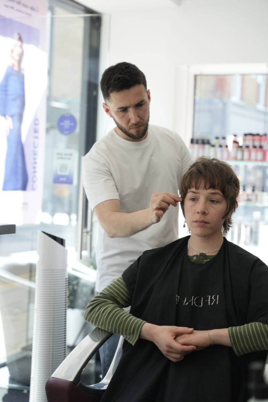 Stylist cutting a client's hair in the salon